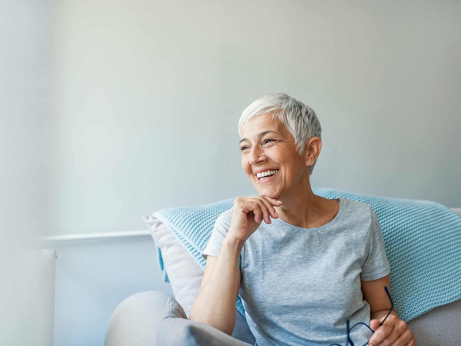Mature woman smiling on couch