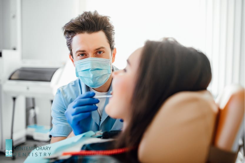 Dentist examining a patient during a routine dental visit